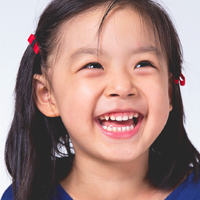 Girl smiling showing baby teeth