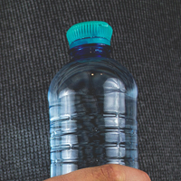 Hand holding a plastic bottle