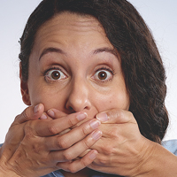 Woman covering her mouth with both hands