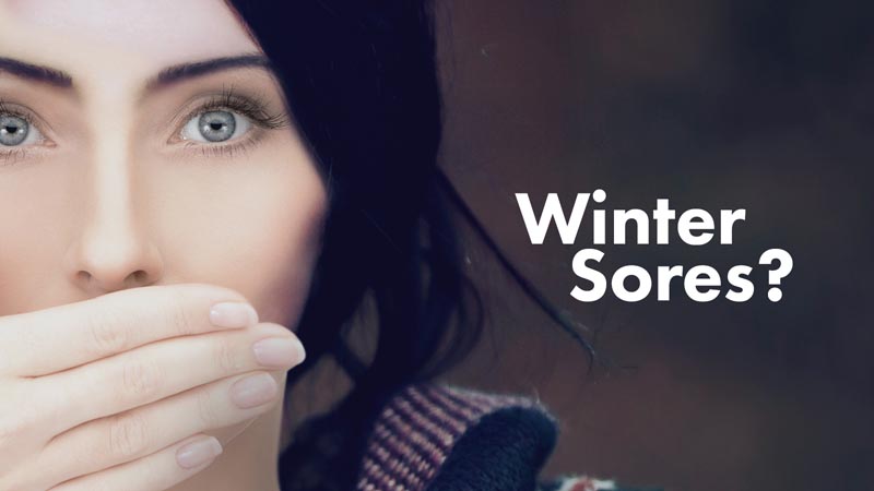 Woman covering her mouth with her hand, with questioning text 'Winter Sores?' indicating a concern about seasonal health issues