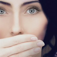 Woman covering her mouth with her hand