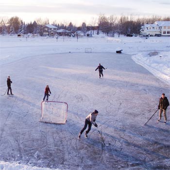 Kids playing ice hockey on a frozen pond
